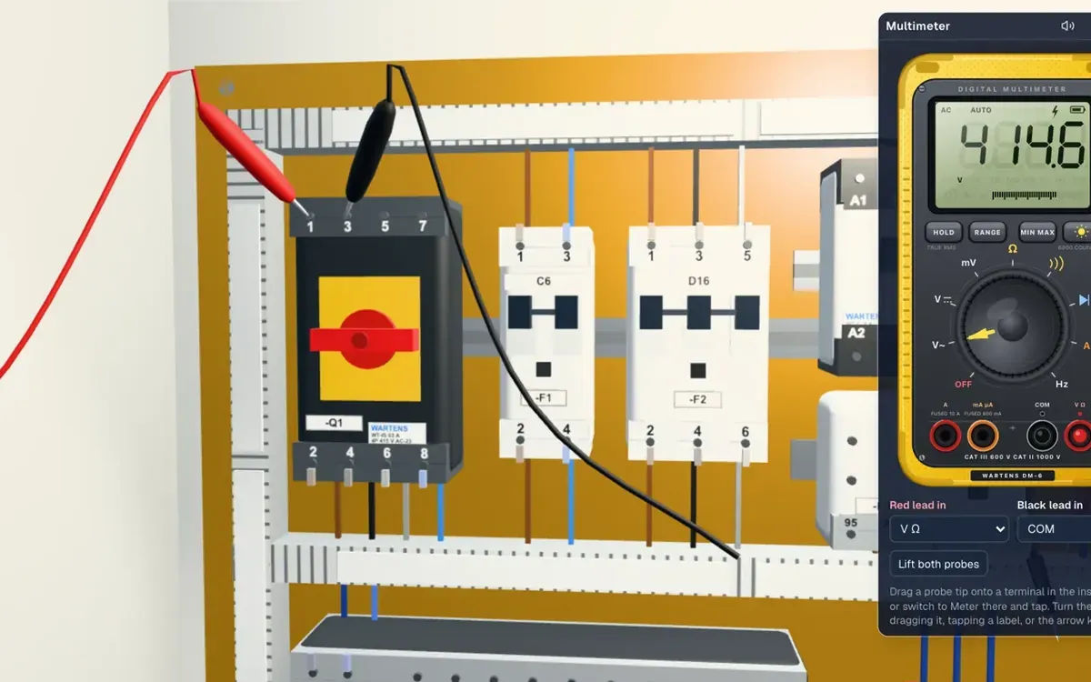 Panel wiring view with the multimeter open on a terminal