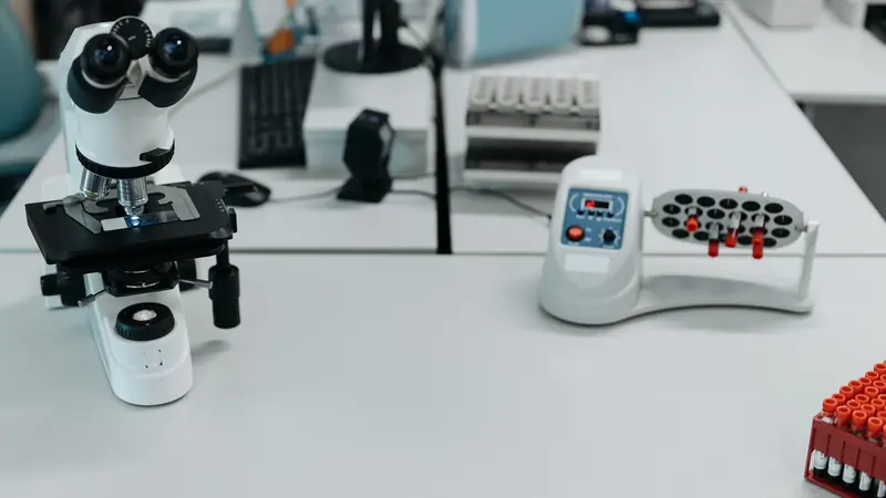 A clean laboratory bench with a microscope and sample equipment, no people or patients.