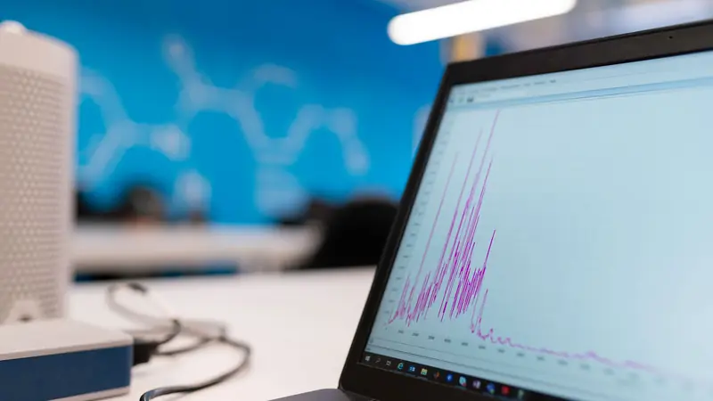 A laptop screen showing a model result plotted as a graph.
