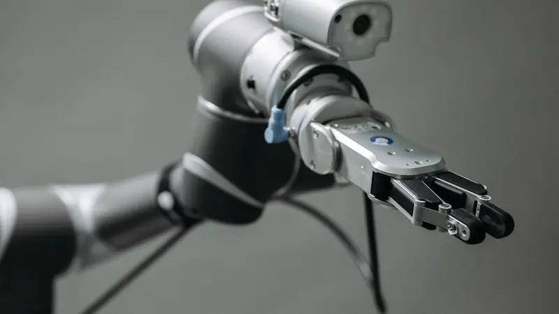 A robot arm with a camera and a gripper, the kind of set-up used for vision inspection.